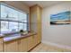 Kitchen features light wood cabinets, window seat, and tile flooring at 4175 104 N Ave, Clearwater, FL 33762
