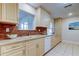 Modern kitchen with light wood cabinets, tile backsplash, and white appliances at 4175 104 N Ave, Clearwater, FL 33762