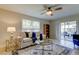Spacious living room with tiled floors, comfy sofa, and access to a screened patio at 4175 104 N Ave, Clearwater, FL 33762