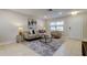 Bright living room with neutral tones, comfortable seating and large windows at 4175 104 N Ave, Clearwater, FL 33762