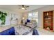 Relaxing living room with tiled floors, neutral decor, and a bookcase at 4175 104 N Ave, Clearwater, FL 33762