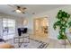 Open living room with tiled floors, access to a screened patio, and view of dining area at 4175 104 N Ave, Clearwater, FL 33762