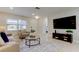 Bright and airy living room with modern furniture and a large TV at 4175 104 N Ave, Clearwater, FL 33762