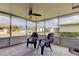Spacious screened patio with two chairs and view of backyard at 4175 104 N Ave, Clearwater, FL 33762