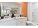 Elegant bathroom with double vanity, large mirror, and an accent wall at 4451 Rachel Falls Dr, Tampa, FL 33610