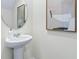 Modern powder room with pedestal sink, and framed art at 4453 Rachel Falls Dr, Tampa, FL 33610