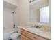 Clean bathroom with tiled walls, vanity, and bathtub at 4651 Summerwind Dr # 26, Sarasota, FL 34234