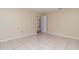 Simple bedroom with tile floor and access to additional rooms at 4651 Summerwind Dr # 26, Sarasota, FL 34234