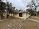 Cute yellow house with palm trees and a brick walkway at 4651 Summerwind Dr # 26, Sarasota, FL 34234