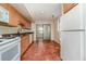 Simple kitchen with wood cabinets and tile floors at 4651 Summerwind Dr # 26, Sarasota, FL 34234
