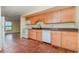 Kitchen features tiled floors, wood cabinets, and a view into adjacent dining area at 4651 Summerwind Dr # 26, Sarasota, FL 34234