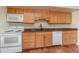 Bright kitchen with wood cabinets, tiled floor, and modern appliances at 4651 Summerwind Dr # 26, Sarasota, FL 34234