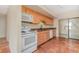 Efficient kitchen with light wood cabinets and appliances at 4651 Summerwind Dr # 26, Sarasota, FL 34234
