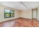 Spacious living area with tile floors and large window at 4651 Summerwind Dr # 26, Sarasota, FL 34234