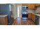 Modern kitchen with stainless steel appliances and wood cabinets at 4915 Bay Ne St # 335, St Petersburg, FL 33703