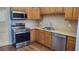 Modern kitchen with stainless steel appliances and wood cabinets at 4915 Bay Ne St # 335, St Petersburg, FL 33703