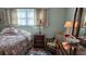 Bedroom with a seashell patterned comforter and wood furniture at 5975 Terrace Park N Dr # 102, St Petersburg, FL 33709