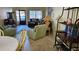 Living room with light teal armchairs and a view to dining area at 5975 Terrace Park N Dr # 102, St Petersburg, FL 33709