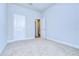 Well-lit bedroom featuring neutral walls and carpet flooring at 6112 Plover Meadow St, Lithia, FL 33547