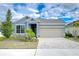 Curb appeal abounds in this charming one-story home featuring a paver driveway and landscaped yard at 6112 Plover Meadow St, Lithia, FL 33547