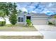 House exterior featuring a stone facade and attractive landscaping at 6112 Plover Meadow St, Lithia, FL 33547