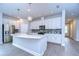 Modern kitchen with white cabinets, quartz countertops, and stainless steel appliances at 6112 Plover Meadow St, Lithia, FL 33547