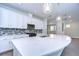 Modern kitchen featuring white cabinets, quartz countertops, and a large island at 6112 Plover Meadow St, Lithia, FL 33547
