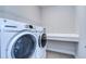 Bright laundry room with washer, dryer, and built-in counter at 6112 Plover Meadow St, Lithia, FL 33547