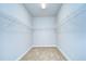 Large walk-in closet with wire shelving and neutral carpeting at 6112 Plover Meadow St, Lithia, FL 33547
