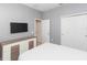 Bedroom with TV, dresser, and access to bathroom at 6206 Windship Ct, Tampa, FL 33647
