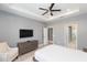 Main bedroom with ensuite bathroom, ceiling fan, and modern dresser at 6206 Windship Ct, Tampa, FL 33647