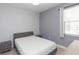 Bright bedroom with a double bed and gray walls at 6206 Windship Ct, Tampa, FL 33647