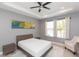 Bright bedroom with a ceiling fan, large window, and modern decor at 6206 Windship Ct, Tampa, FL 33647