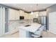 Modern kitchen with white cabinets and breakfast bar at 6206 Windship Ct, Tampa, FL 33647