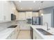 Modern kitchen with white cabinets and large island at 6206 Windship Ct, Tampa, FL 33647