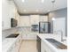 Modern kitchen with white cabinets, quartz countertops and stainless steel appliances at 6206 Windship Ct, Tampa, FL 33647
