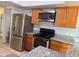 Stainless steel appliances and wood cabinets in kitchen at 704 Gasparino Ct, Seffner, FL 33584