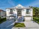 White two-story home with double garage and brick steps at 721 Brightwaters Ne Blvd, St Petersburg, FL 33704