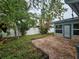 Landscaped backyard with brick patio and privacy fence at 7711 Innis Ct, St Petersburg, FL 33709