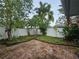 Landscaped backyard with brick patio and privacy fence at 7711 Innis Ct, St Petersburg, FL 33709