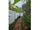 Brick pathway leads to a gate, alongside a white fence at 7711 Innis Ct, St Petersburg, FL 33709