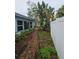 Brick pathway and lush greenery line the home's exterior at 7711 Innis Ct, St Petersburg, FL 33709