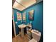 Stylish bathroom with pedestal sink and ocean theme at 7711 Innis Ct, St Petersburg, FL 33709