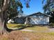 Single story home with two car garage and landscaped lawn at 7711 Innis Ct, St Petersburg, FL 33709