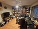 Home office with ample built-in shelving and hardwood floors at 7711 Innis Ct, St Petersburg, FL 33709