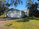 Single story home with a two car garage and neat lawn at 7711 Innis Ct, St Petersburg, FL 33709