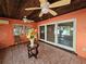 Sunroom with tiled floors, wood ceiling, and sliding glass doors at 7711 Innis Ct, St Petersburg, FL 33709