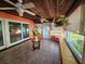 Sunroom with tiled floors, wood ceiling, and sliding glass doors at 7711 Innis Ct, St Petersburg, FL 33709