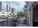 Balcony view of city street, palm trees, and modern buildings at 1010 Central Ave # 106, St Petersburg, FL 33705