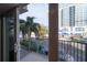 Residential balcony with view of city street and palm trees at 1010 Central Ave # 106, St Petersburg, FL 33705